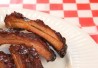 Babyback spare barbeque pork ribs on a checkered restaurant tissue Babyback spare barbeque pork ribs on a checkered restaurant tissue