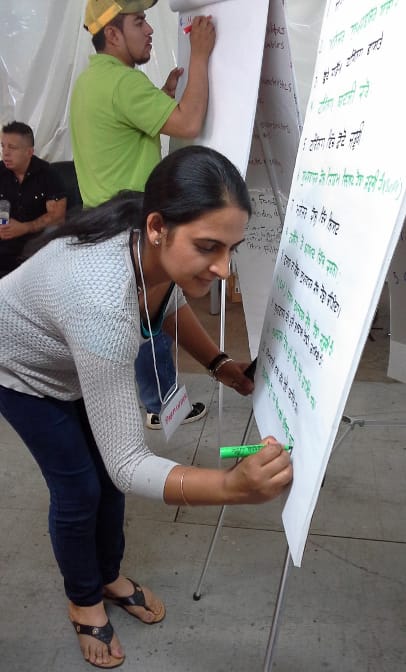 Windset Farms workers Byron Lopez (background) and Parminder Khosa helped with simultaneous interpreting during an EFI session at the greenhouse grower's facility.