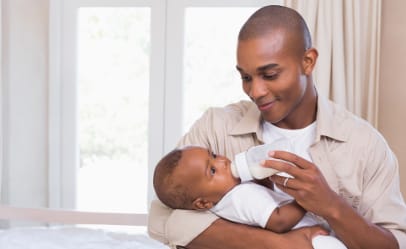 man-feeding-baby-bottle