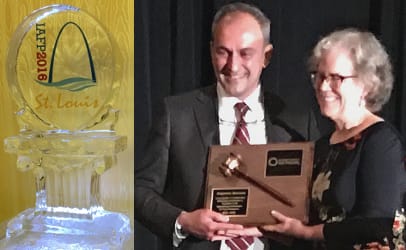 Outgoing president Alejandro Mazzotta accepts his gavel on a plaque from incoming president Linda Harris at the annual meeting of the International Association for Food Protection. (Photos by Coral Beach)