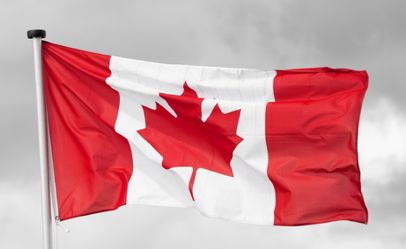 national flag of canada on a black & white cloudy background