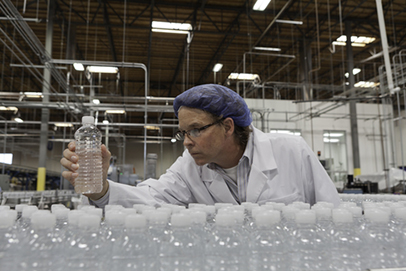 http://www.dreamstime.com/royalty-free-stock-image-quality-control-worker-checking-bottled-water-bottling-plant-image29668236