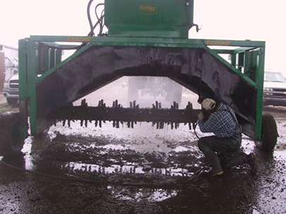 Compost turner used for windrow churning. To avoid across contamination, compost turner was thoroughly washed by farm workers in between study treatments.