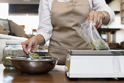 Store employee measuring ingredients