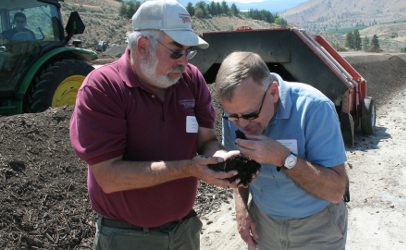 Mike Taylor (right) took his team on the road to collect feedback on proposed rules mandated by the Food Safety Modernization Act. He tramped through fields, toured packing and processing plants and visited operations directly related to food production, including a composting operation (shown here) where he got up close and personal with the staff and the stuff they manage.