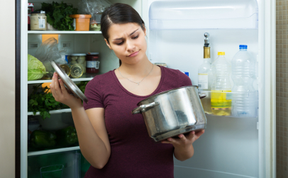 woman at refrigerator with rotten food