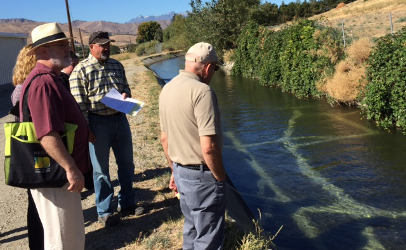 Wenatchee (WA) Reclamation District Manager Rick Smith, center, shows FDA's Stephen Ostroff, right, and colleagues an open irrigation canal system. (Photo courtesy of FDA)