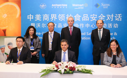 Wal-Mart Vice President for Food Safety Frank Yiannas, seated at center, with officials from IBM Corp and Tsinghua University pose for photos during the October 2016 announcement of the new food safety center.