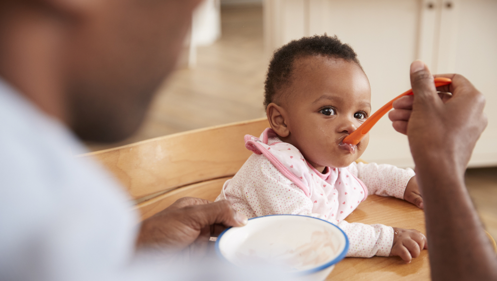 dad feeding baby food