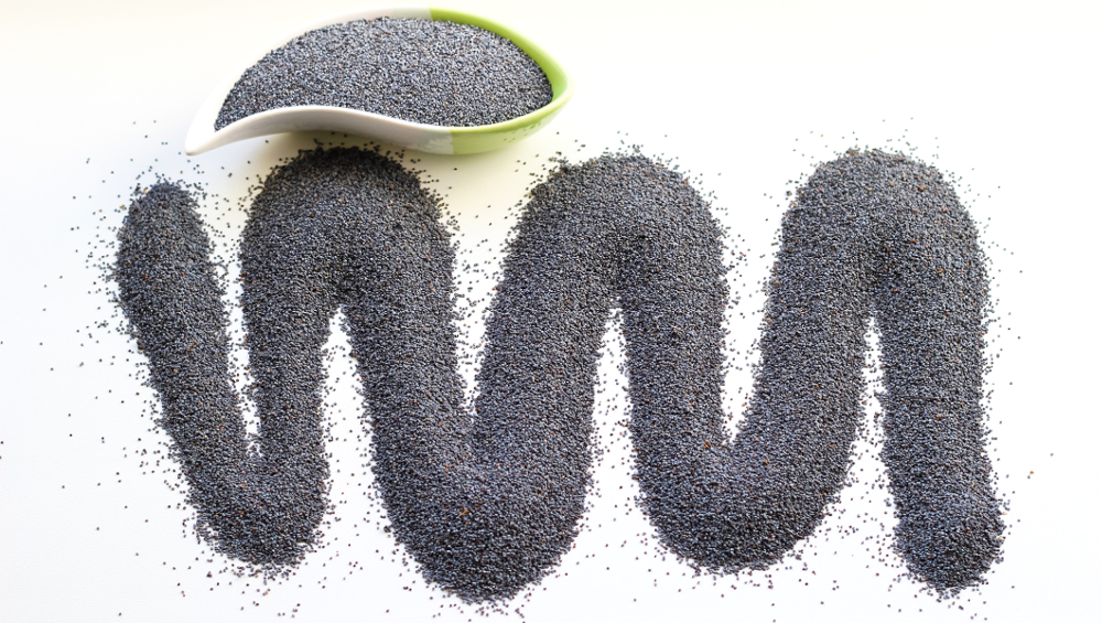 Poppy seeds wave on white background.