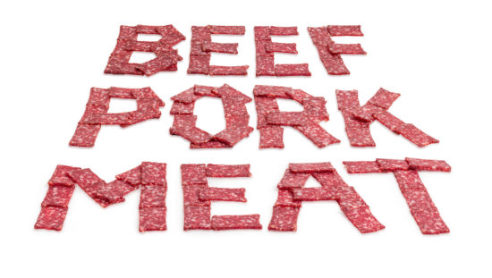 Words MEAT, PORK, BEEF laid out with sausage slices