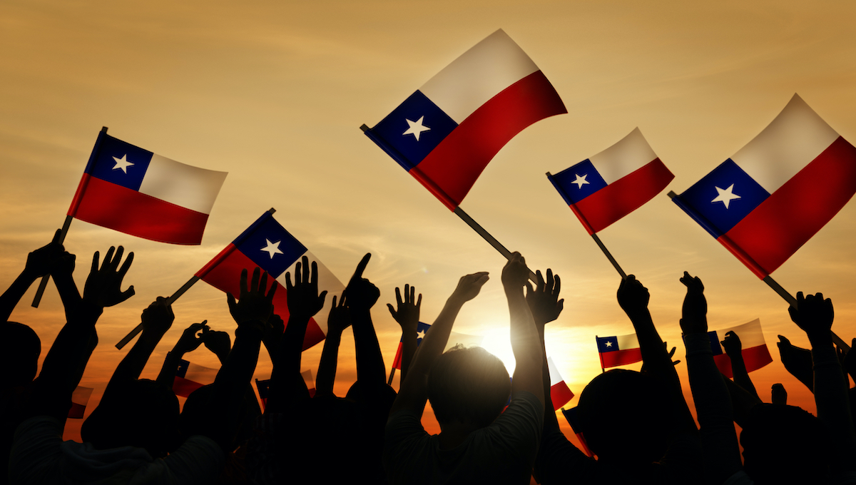 Silhouettes of People Holding Flag of Chile