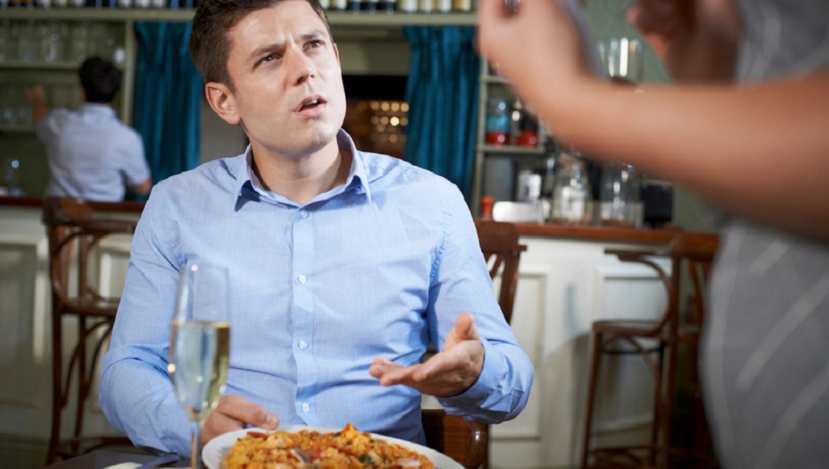 Customer In Restaurant Complaining To Waitress About Food