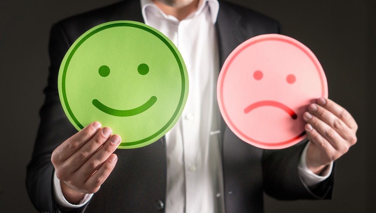 Business man with happy smiling and sad unhappy cardboard paper